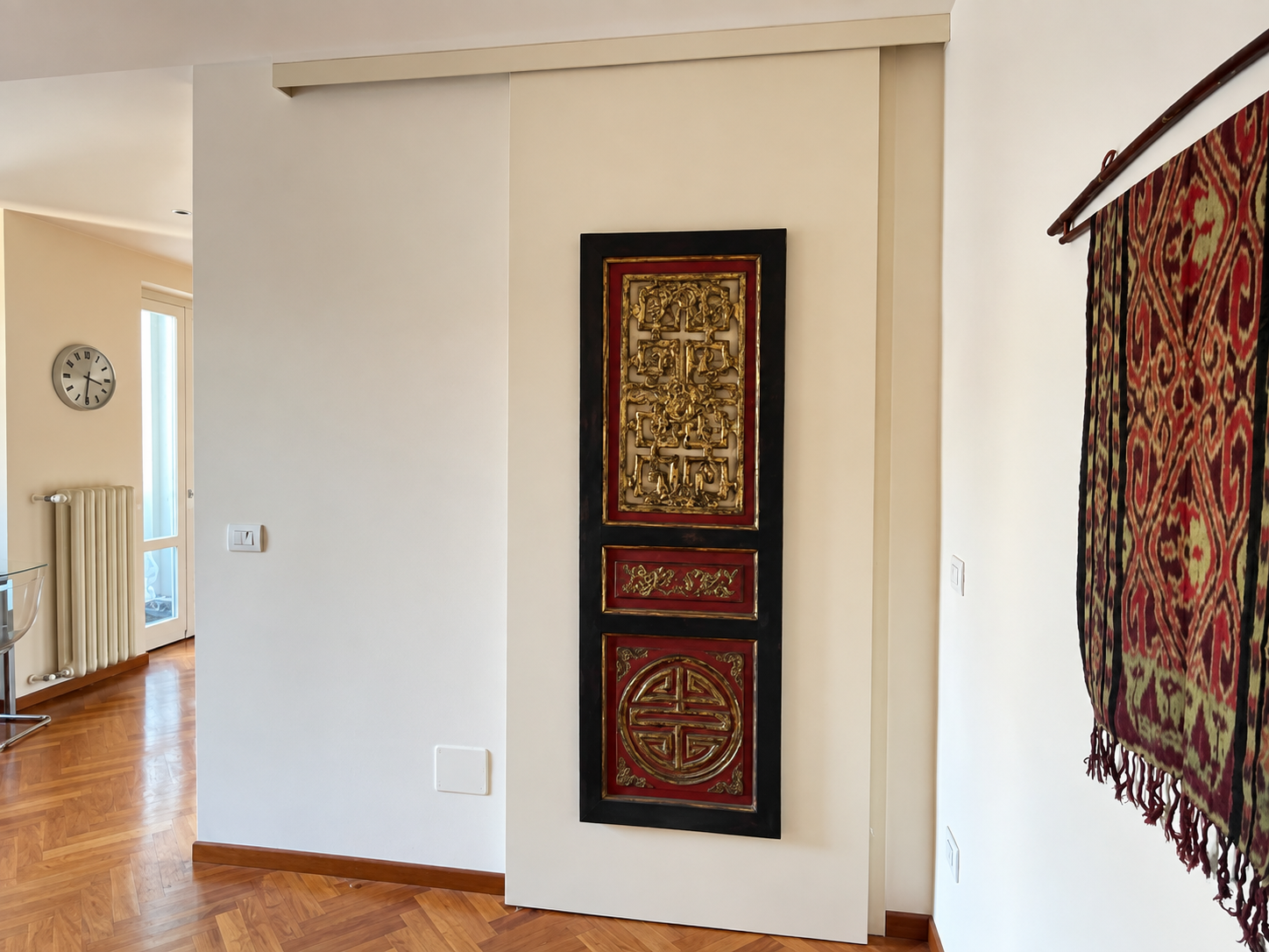 Turin apartment with an antique pagoda panel integrated into a sliding door